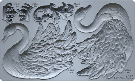 I.O.D. Swans Mould by Iron Orchid Designs, gray silicone, shows two swans, ornate leaves, and volume/weight labels.