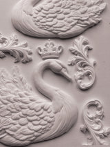 White swan relief with crown and ornate flourishes, made with IOD Swans Mould on a light textured background.
