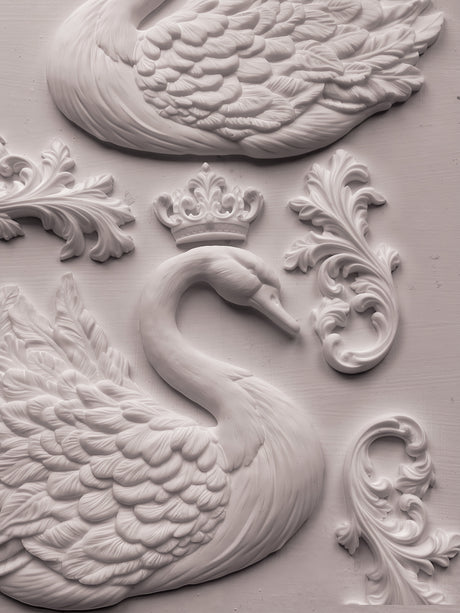White swan relief with crown and ornate flourishes, made with IOD Swans Mould on a light textured background.