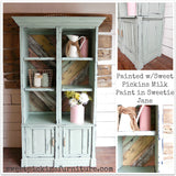 Mint green cabinet with rustic wood back, finished in Sweetie Jane by Old Fashioned Milk Paint, with open shelves and doors.