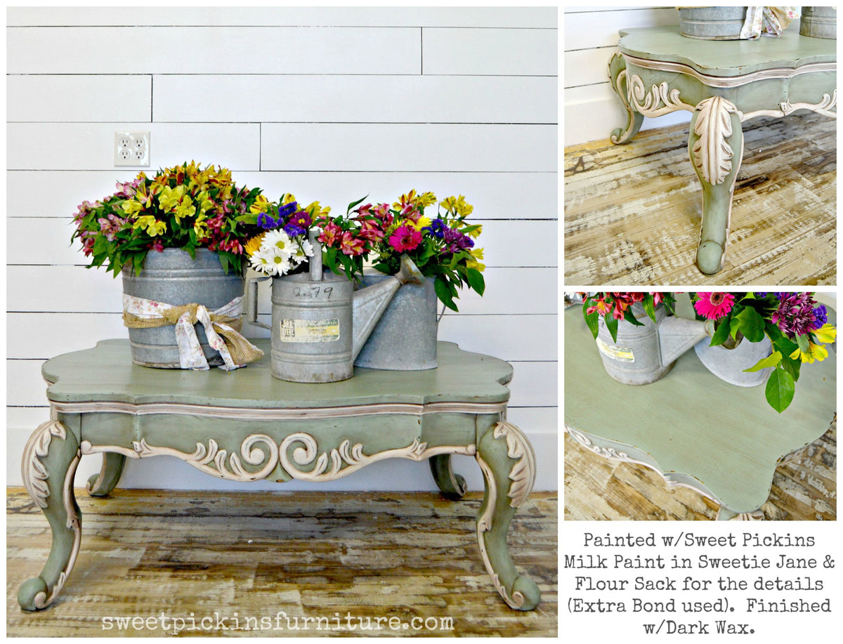 Coffee table painted Sweetie Jane by Old Fashioned Milk Paint with three metal vases of colorful flowers on top.
