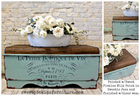 Vintage wooden chest in Sweetie Jane by Old Fashioned Milk Paint, topped with white blooms in a white container.