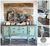Sideboard finished in Sweetie Jane by Old Fashioned Milk Paint, styled with vintage décor, books, and flowers.