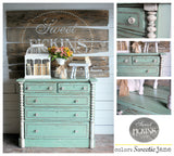 Mint green dresser painted with Sweetie Jane by Old Fashioned Milk Paint, topped with decor, flowers, and a birdcage.
