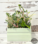 Light green rectangular planter painted Sweetwater by Old Fashioned Milk Paint, holding faux stems.