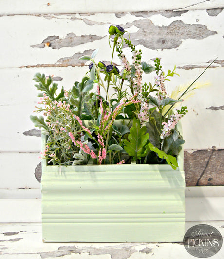 Light green rectangular planter painted Sweetwater by Old Fashioned Milk Paint, holding faux stems.