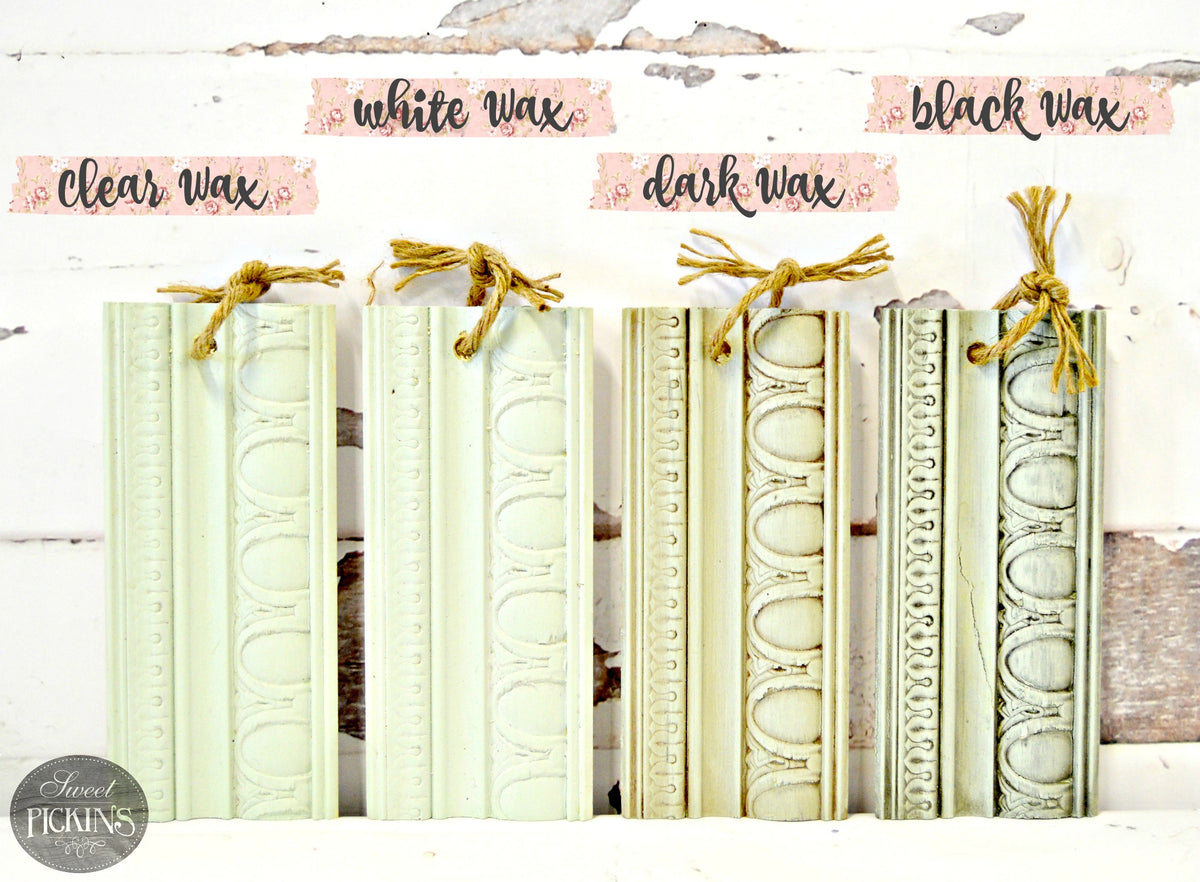 Four wood samples with Sweetwater by Old Fashioned Milk Paint: clear, white, dark, and black, tied with twine.