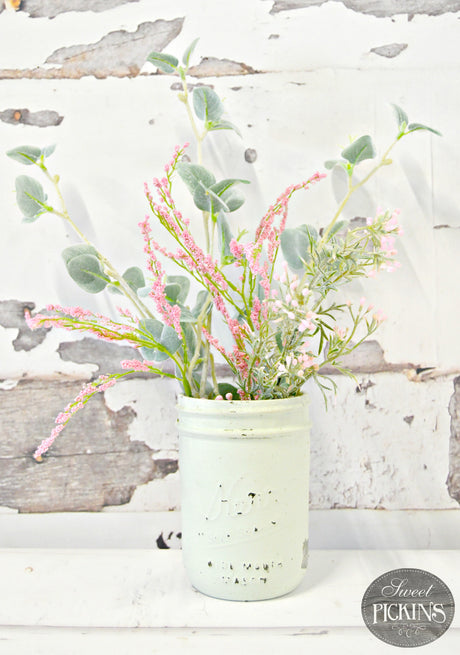 White jar with pink and green flowers in front of wall painted Old Fashioned Milk Paint Sweetwater color.