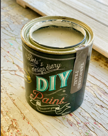Open can of Tarnished Pearl DIY Paint by DIY Paint Co. displayed on a distressed wooden surface.