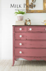 Pink dresser in Texas Rose Milk Paint by Homestead House with white knobs.