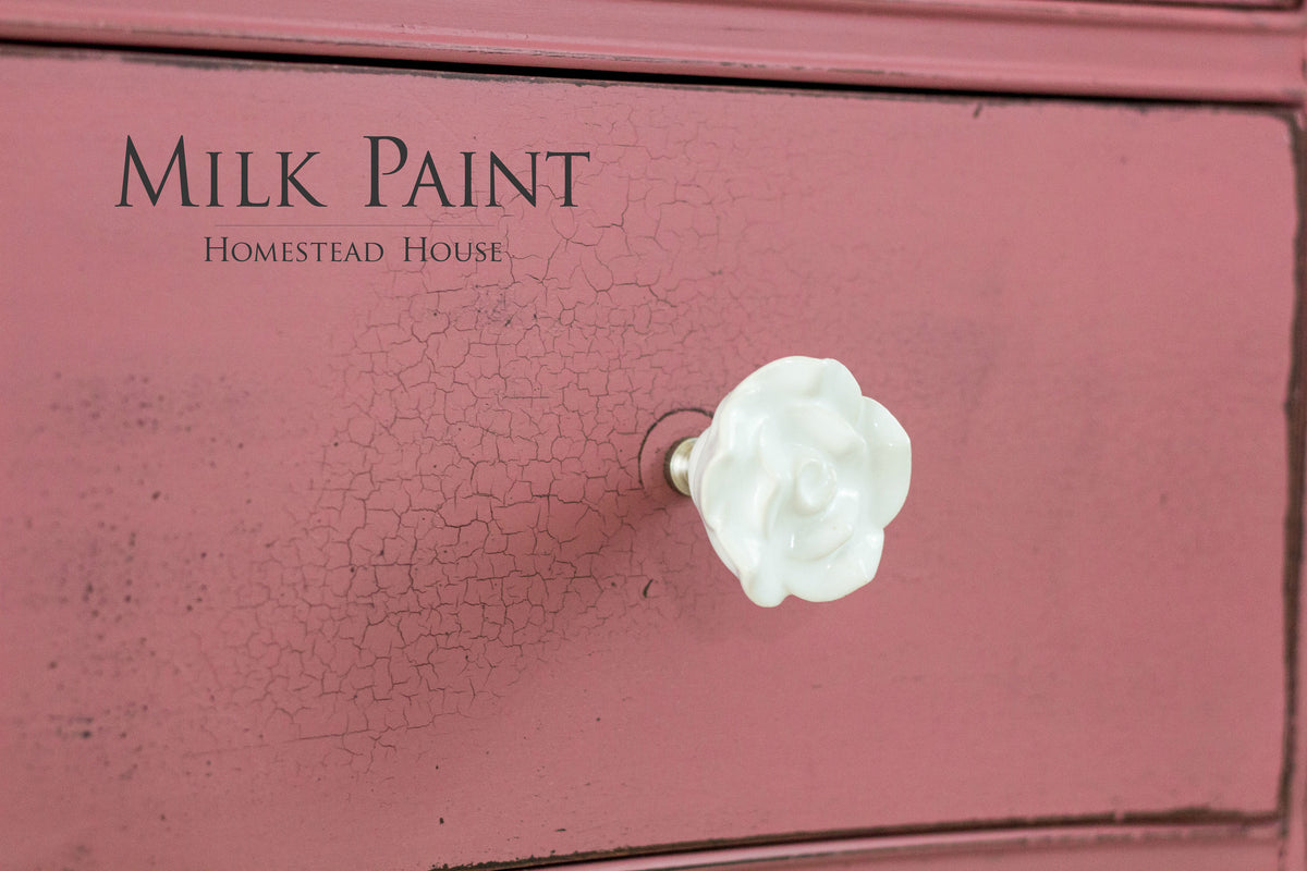 Pink drawer in Texas Rose Milk Paint by Homestead House, crackle finish, with a white flower-shaped knob.