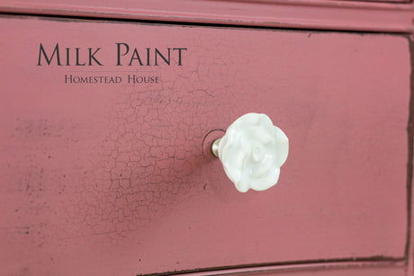 Pink drawer in Texas Rose Milk Paint by Homestead House, crackle finish, with a white flower-shaped knob.