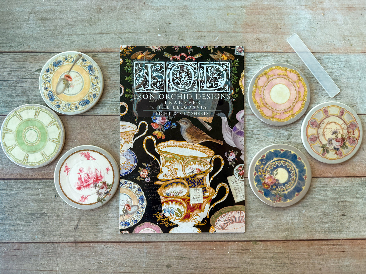 The Belgravia Transfer by IOD from I.O.D. displayed with antique tableware and six vintage-patterned ceramic coasters.