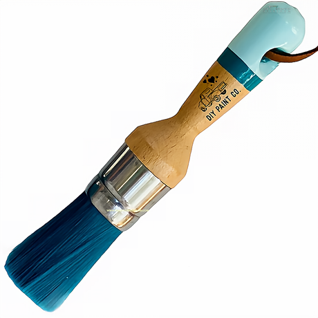 The Little Dipper DIY Paintbrush by DIY Paint Co. with ultra soft bristles, wood handle, blue tip, and leather strap.