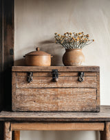The Waltz Stamp by IOD displayed on a wooden chest with vintage sheet music and a vase of dried flowers on top.