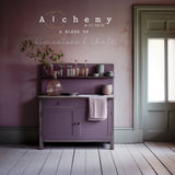 Purple cabinet with glassware and dishes; “Alchemy by Fusion” text on pink background.