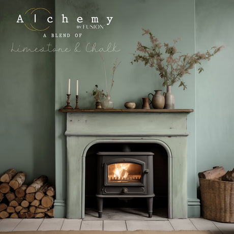 Wood stove in rustic fireplace with vases on mantel; walls painted Fusion Mineral Paint Thyme Alchemy green.