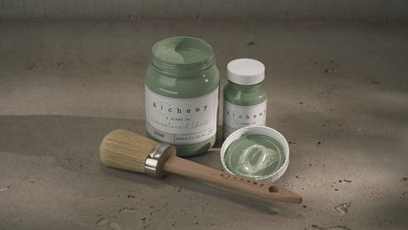 Large and small jars of Fusion Mineral Paint Thyme Alchemy, open lid, and brush displayed together.