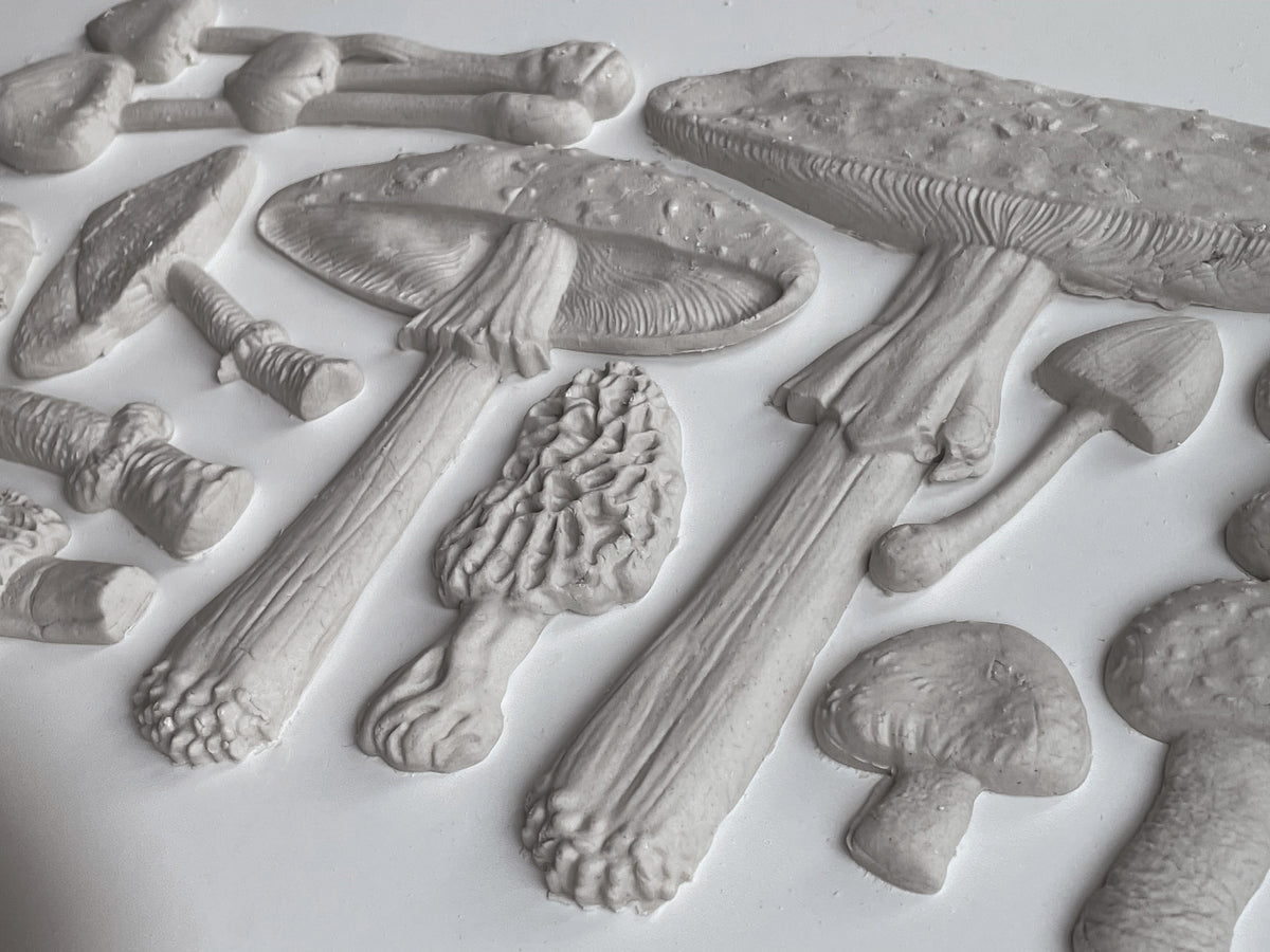 Mushrooms formed with IOD Toadstool Mould displayed on an embossed white surface.
