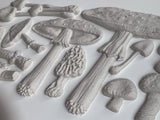 Mushrooms formed with IOD Toadstool Mould displayed on an embossed white surface.