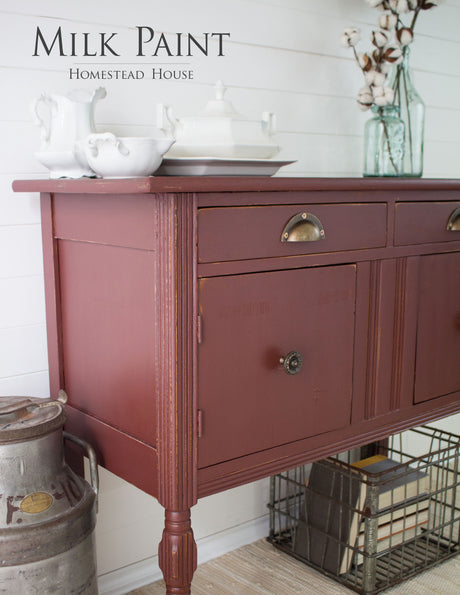 Trading Post Red Milk Paint by Homestead House on a sideboard with brass handles.