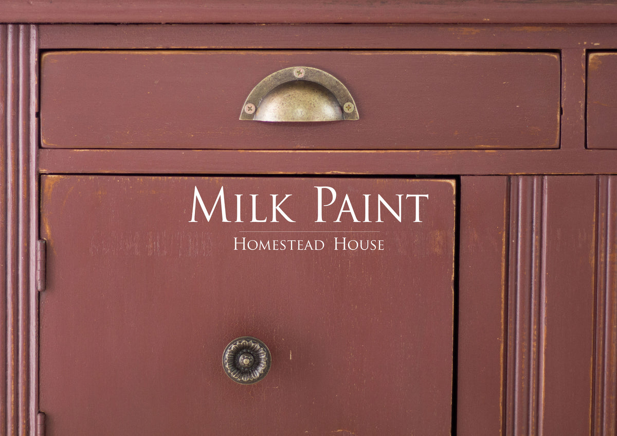 Cabinet painted in Trading Post Red Milk Paint by Homestead House, brand name visible on front.