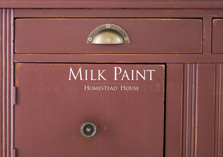 Cabinet painted in Trading Post Red Milk Paint by Homestead House, brand name visible on front.