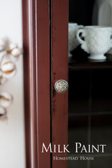Cabinet in Trading Post Red Milk Paint by Homestead House, featuring a decorative knob and teacups.