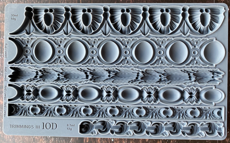 Trimmings 3 Mould by I.O.D. with five ornate borders and measurements displayed on the mould.
