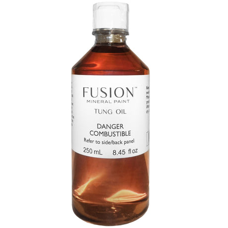 Fusion Mineral Paint Tung Oil clear bottle, amber liquid, water-resistant finish, visible safety warnings on label.