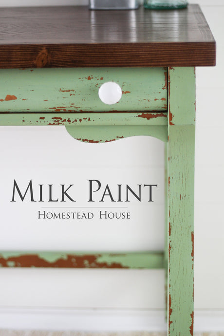 Green table with worn paint and white knob; text reads: Upper Canada Green Milk Paint by Homestead House.