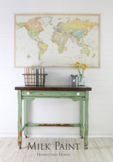 Green table painted in Homestead House Upper Canada Green Milk Paint with books and flowers on top.