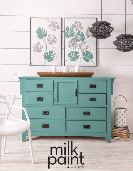 Teal dresser painted with Fusion Mineral Paint Velvet Palm, shown beneath botanical prints with woven pendants nearby.