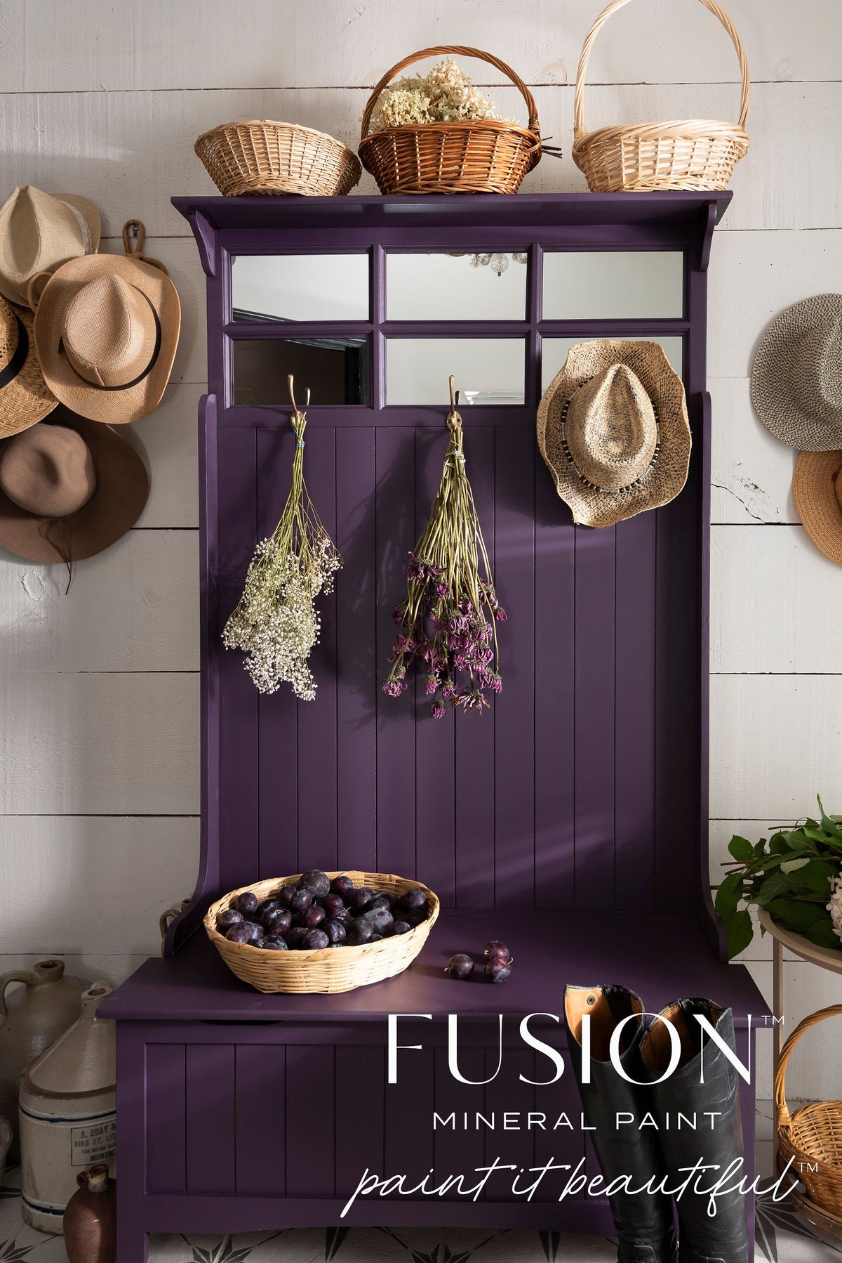 Hall tree in Velvet Plum by Fusion Mineral Paint with baskets, hats, flowers, and plums on display.