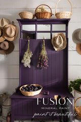 Hall tree in Velvet Plum by Fusion Mineral Paint with baskets, hats, flowers, and plums on display.
