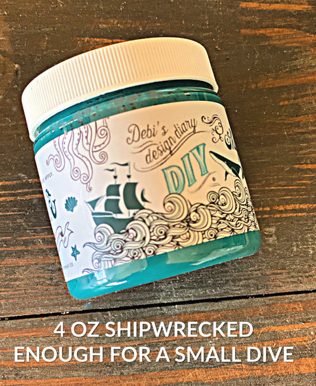 4 oz DIY Paint Co. Verdigris Shipwrecked DIY Wax jar on a wooden surface.