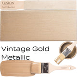 Fusion Mineral Paint Vintage Gold Metallic with mica pigments on brush and swatch display.