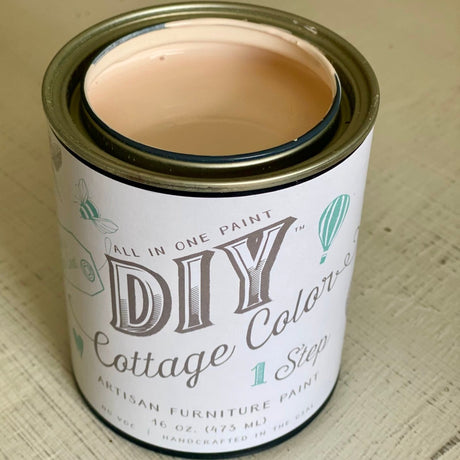 Open can of DIY Paint Co. Vintage Pink Cottage Color paint shown on a beige surface.