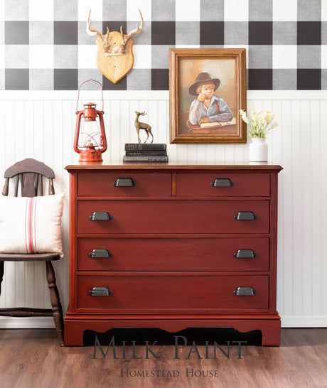 Red dresser painted with Homestead House Voyageur Milk Paint, black handles, vintage style.