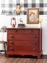 Red dresser with black handles, painted in Homestead House Voyageur Milk Paint.