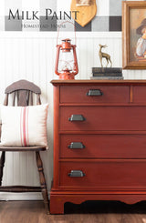 Bold red dresser in Homestead House Voyageur Milk Paint with black handles.