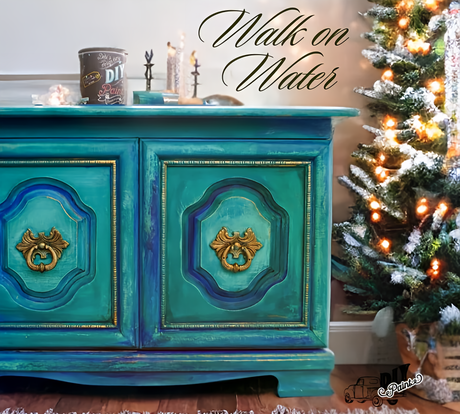 Cabinet painted in DIY Paint Co. Walk on Water, teal and gold hues, positioned beside a lit tree.
