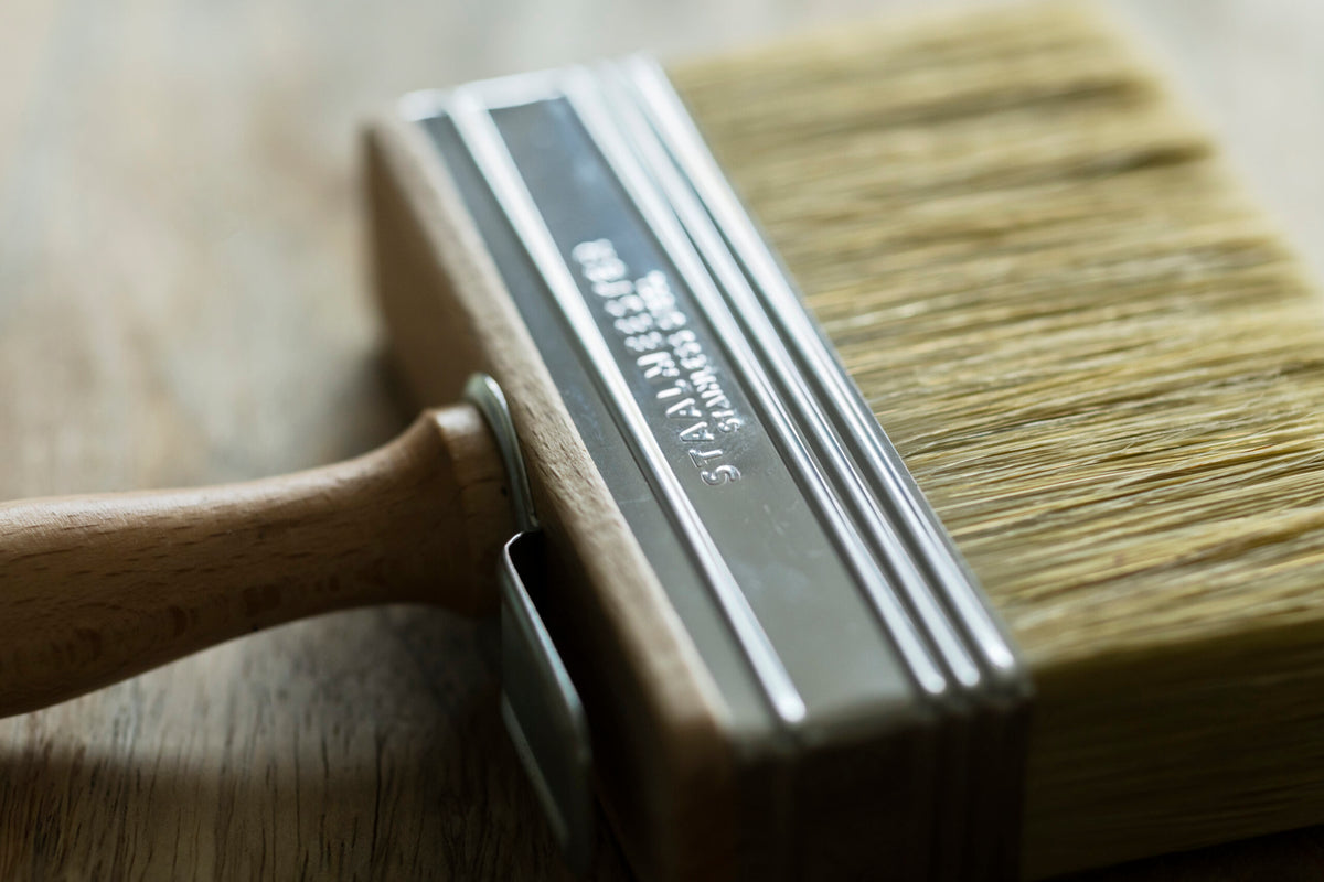 Staalmeester Wall Brush Series 3005 with wooden handle, shown resting on a wooden surface.