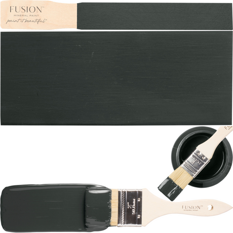 Brush with green-grey paint, black board, and open can of Wellington Fusion Mineral Paint.