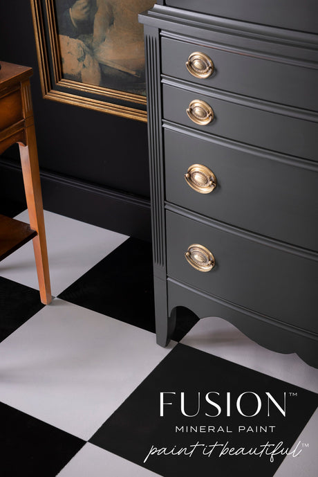 Black dresser with gold handles, painted Wellington Fusion Mineral Paint, on a checkered floor.