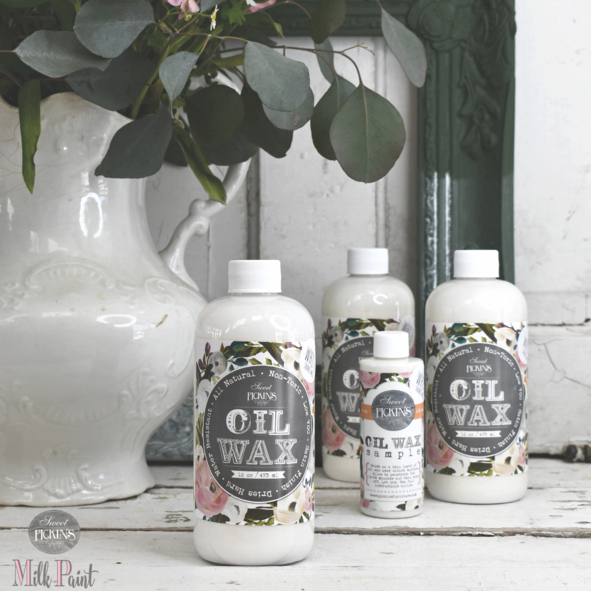Four Old Fashioned Milk Paint White Oil Wax bottles arranged together.