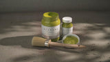 Three Willow Alchemy Paint jars by Fusion Mineral Paint with a paintbrush on a gray surface.