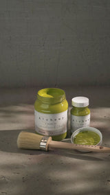 Open and closed Willow Alchemy Paint by Fusion Mineral Paint with paintbrush and dish of chalk-style paint.