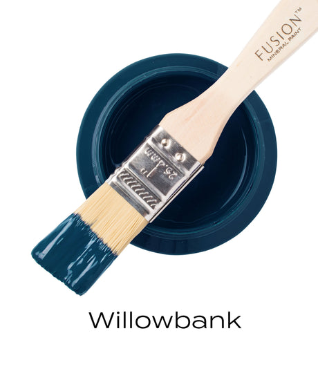 Brush with blue-green Willowbank Fusion Mineral Paint resting on open can.
