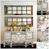 Distressed white sideboard with ornate detailing, floral accents, and Old Fashioned Milk Paint window panes above.